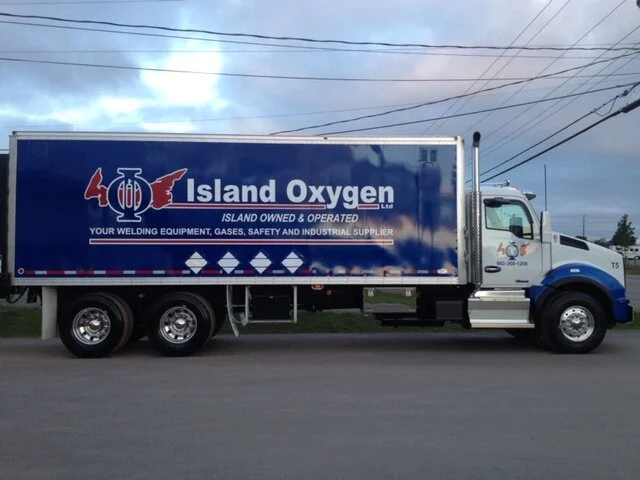 An Island Oxygen delivery truck with the Island owned and operated slogan on the side